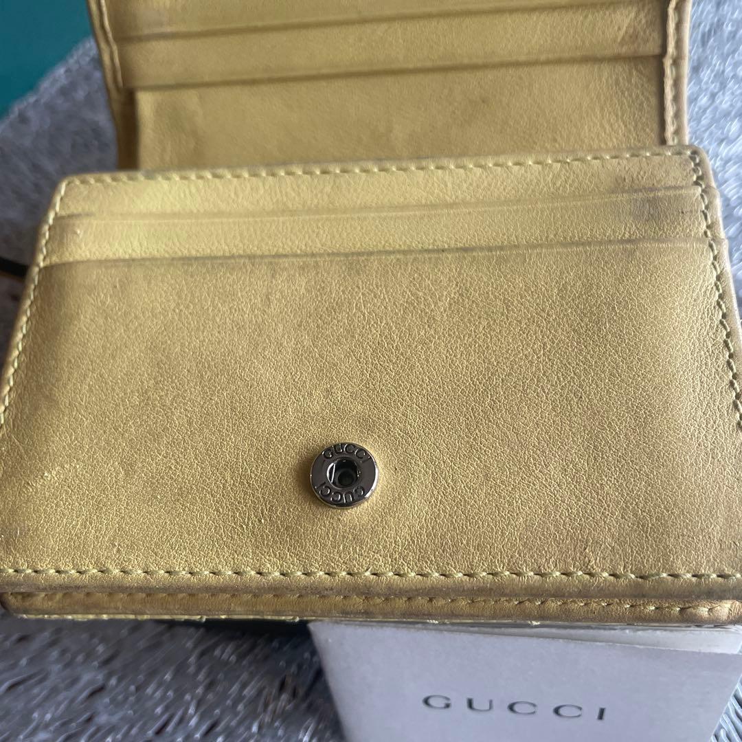 グッチ折財布　パイソンマーモントイエロー。箱付き