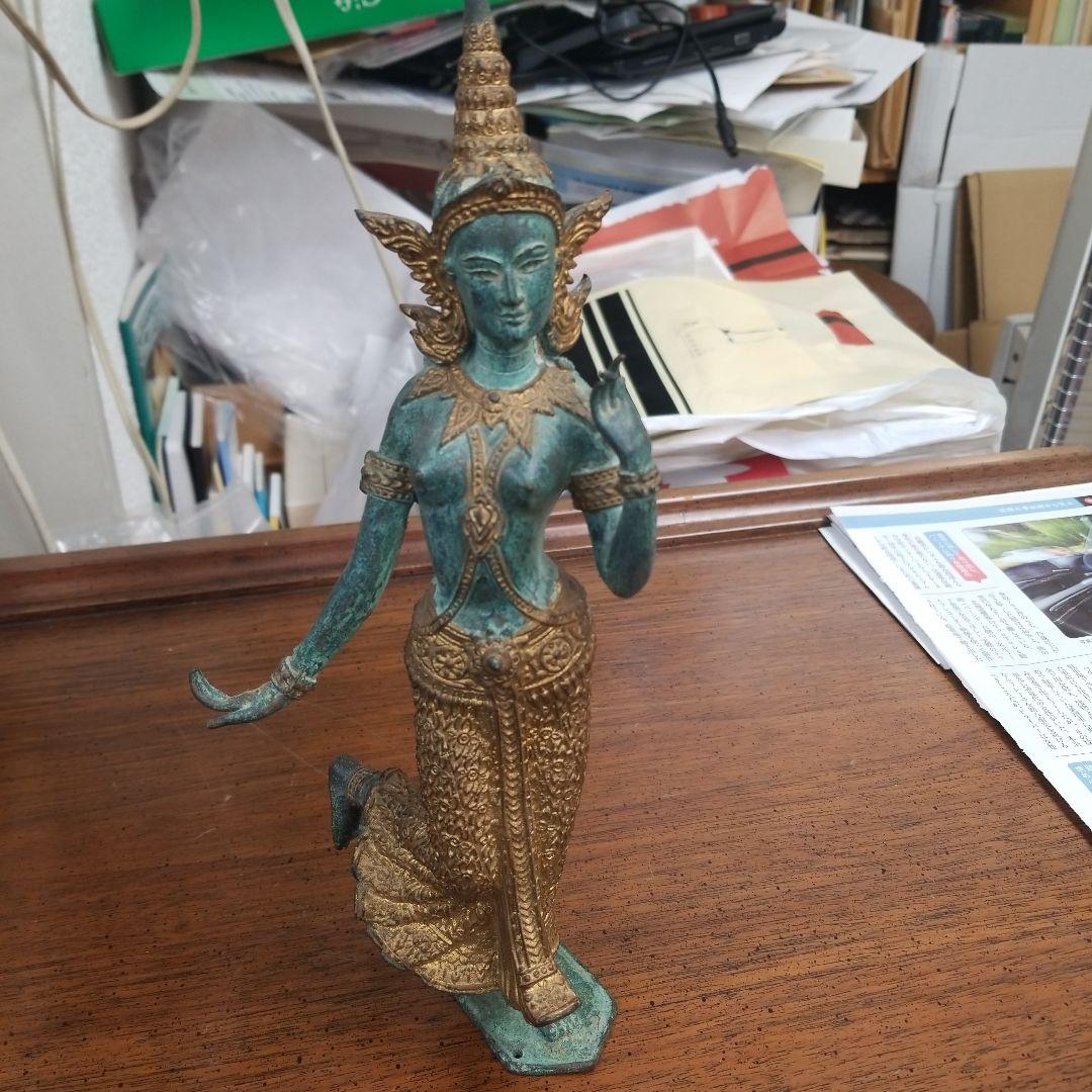 青銅色と金色のアジアの立像