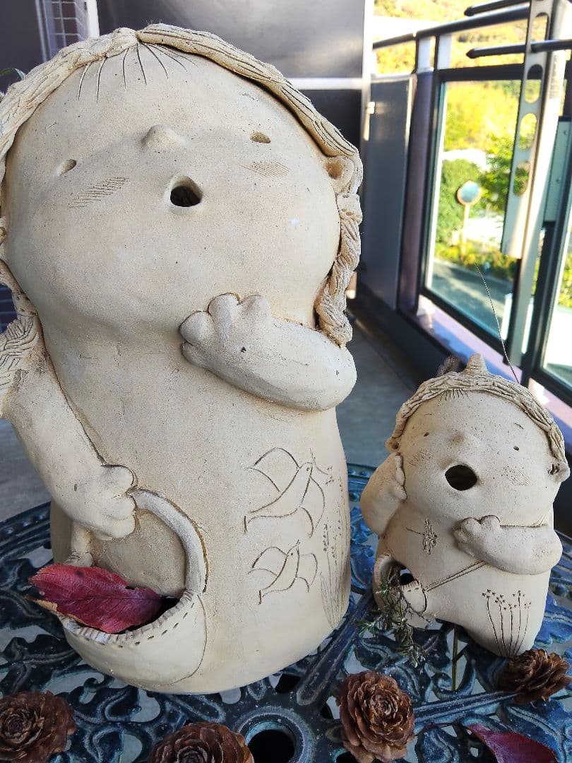 素焼き陶器·花かごを持った三つ編みの女の子と、ツノが愛らしい幼い鬼っ子