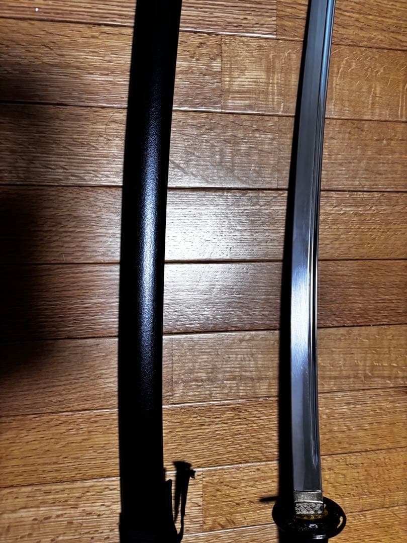 湾曲した刃の刀 黒い鞘と柄