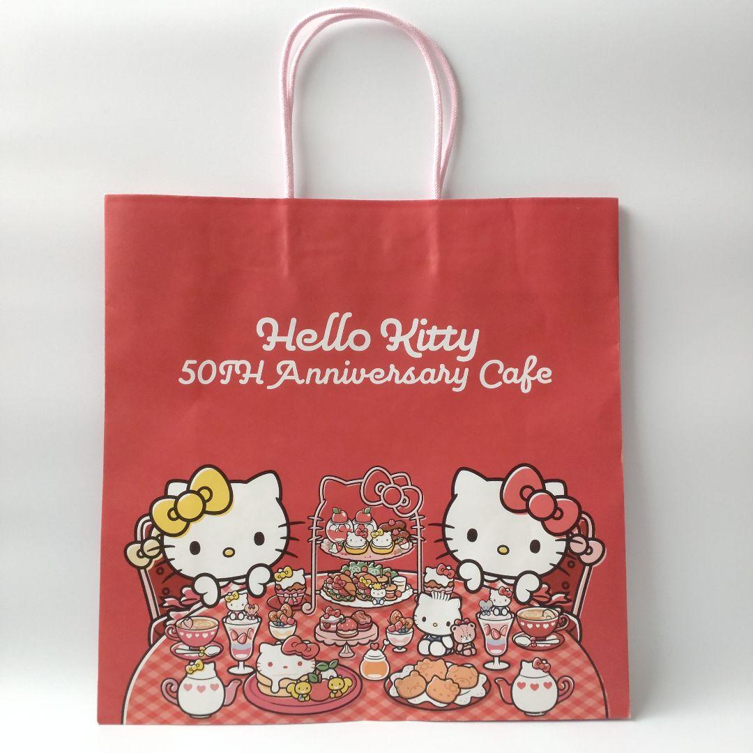 キティ 50周年記念カフェ 缶バッジ 巾着 ステッカー ショッパー