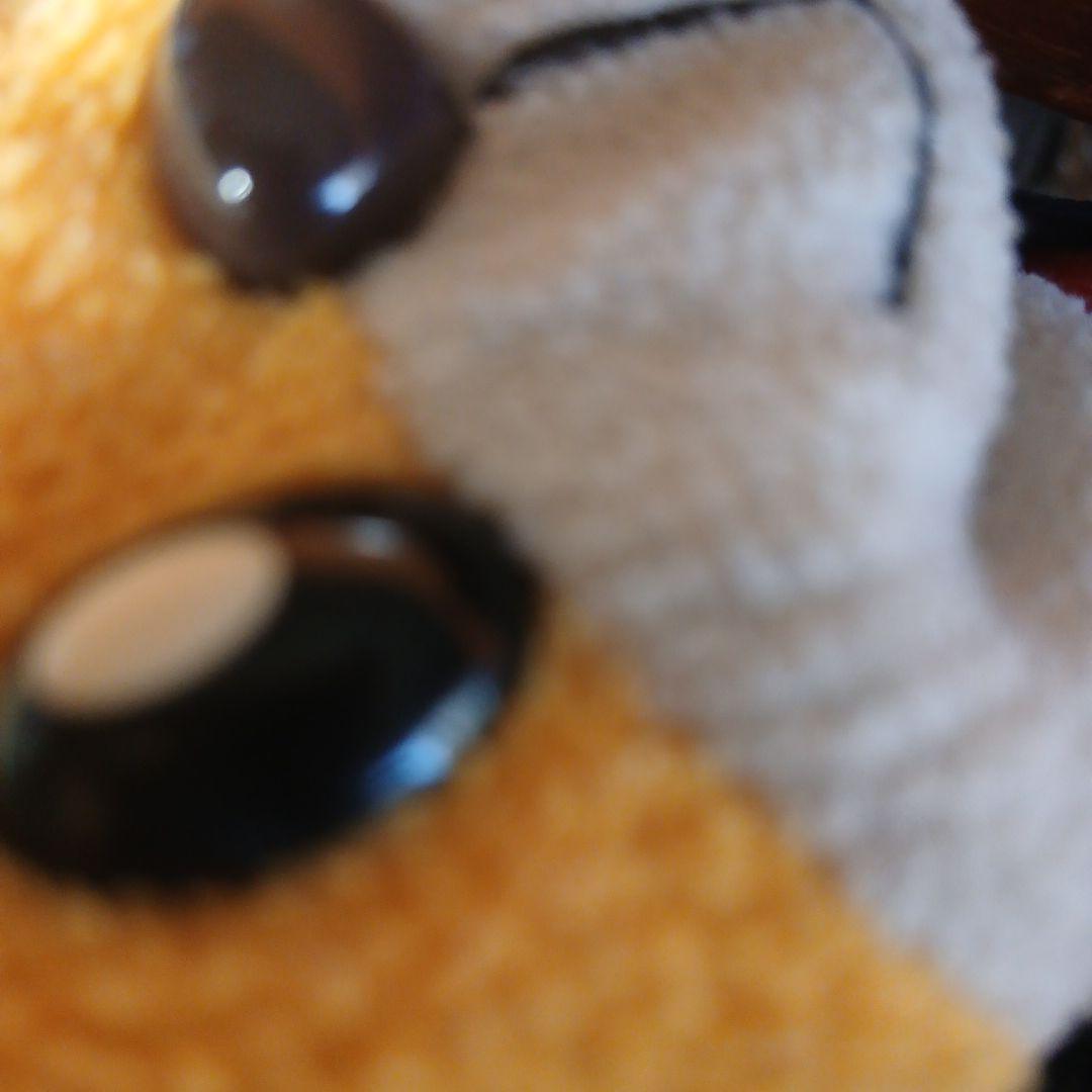 オレンジ色の笑顔のぬいぐるみ