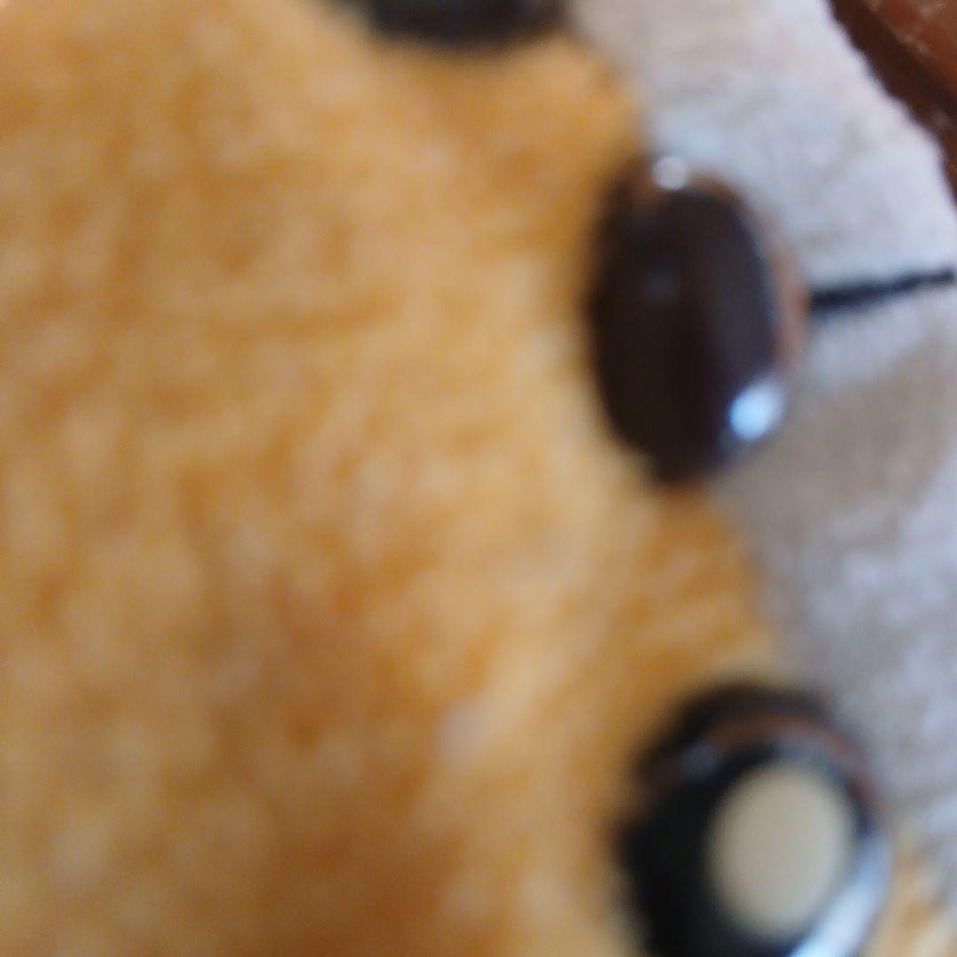 オレンジ色の笑顔のぬいぐるみ